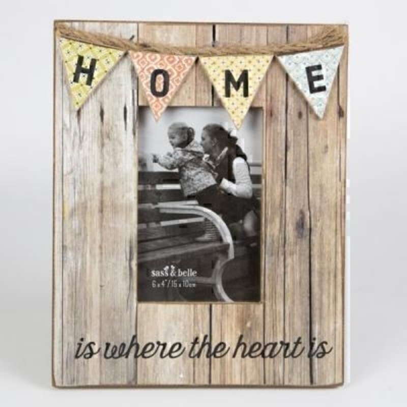 Home Bunting Photo Frame by Sass and Belle. This rustic distressed look wooden picture frame had really beautiful bunting detailing with 'Home is where the heart is caption' Has a stand at the back so that it can be placed on a flat surface. Size 26x20